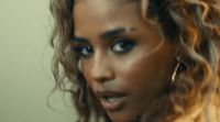 a close up of a person with curly hair