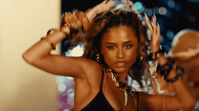 a woman in a black top is dancing