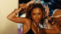 a woman in a black top is dancing