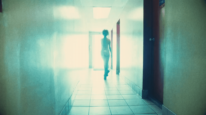 a person walking down a hallway in a building