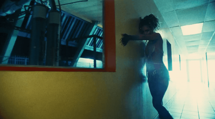 a woman leaning against a wall in a hallway