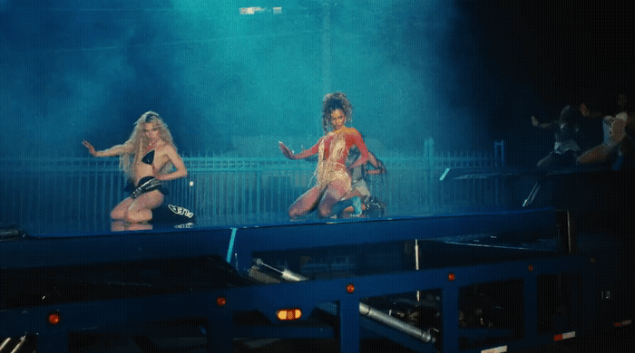 a couple of women that are standing on a stage