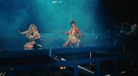 a couple of women that are standing on a stage