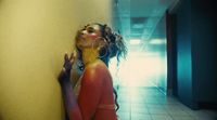 a woman leaning against a wall in a hallway