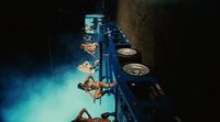 a couple of women laying on top of a blue truck
