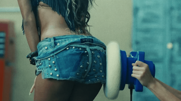 a woman in a short skirt holding a hair dryer