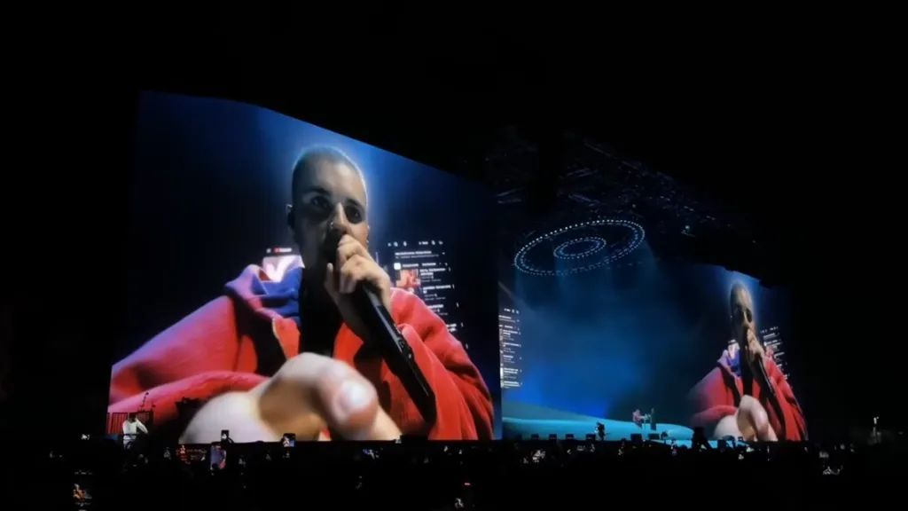 a man that is on a stage with a microphone