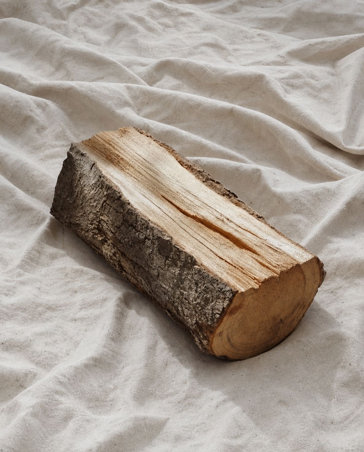 a piece of wood sitting on top of a white sheet