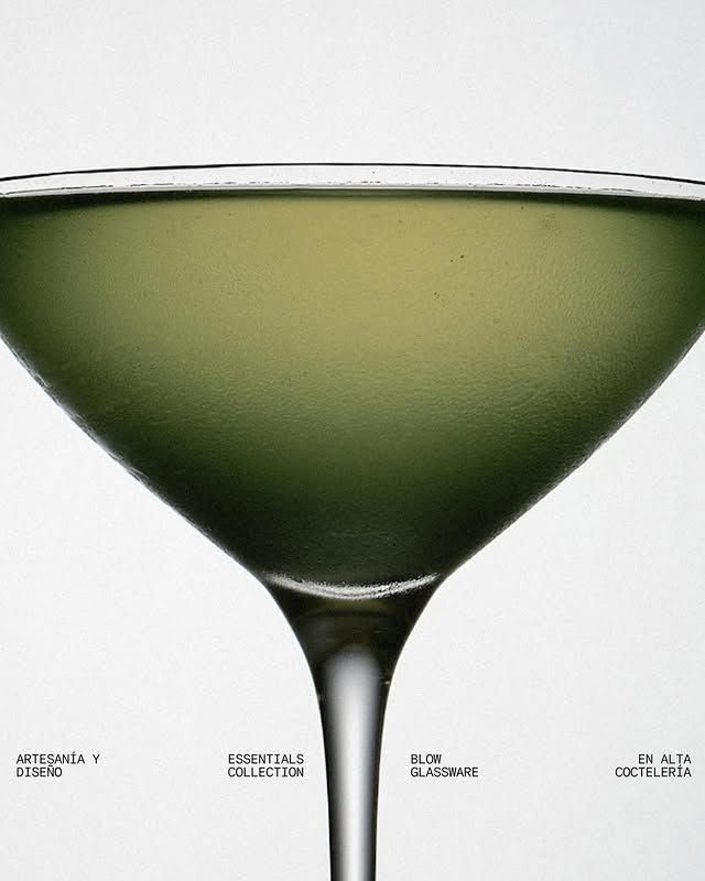 a martini glass filled with a green liquid