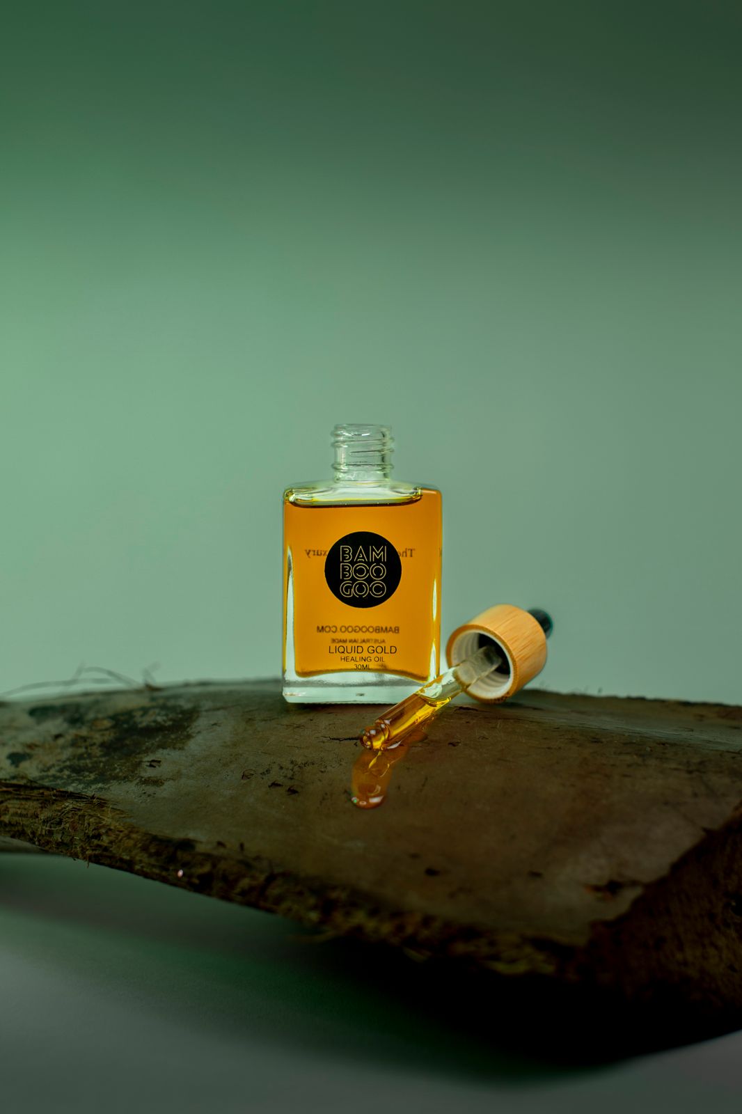 a bottle of oil sitting on top of a wooden table