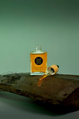 a bottle of oil sitting on top of a wooden table