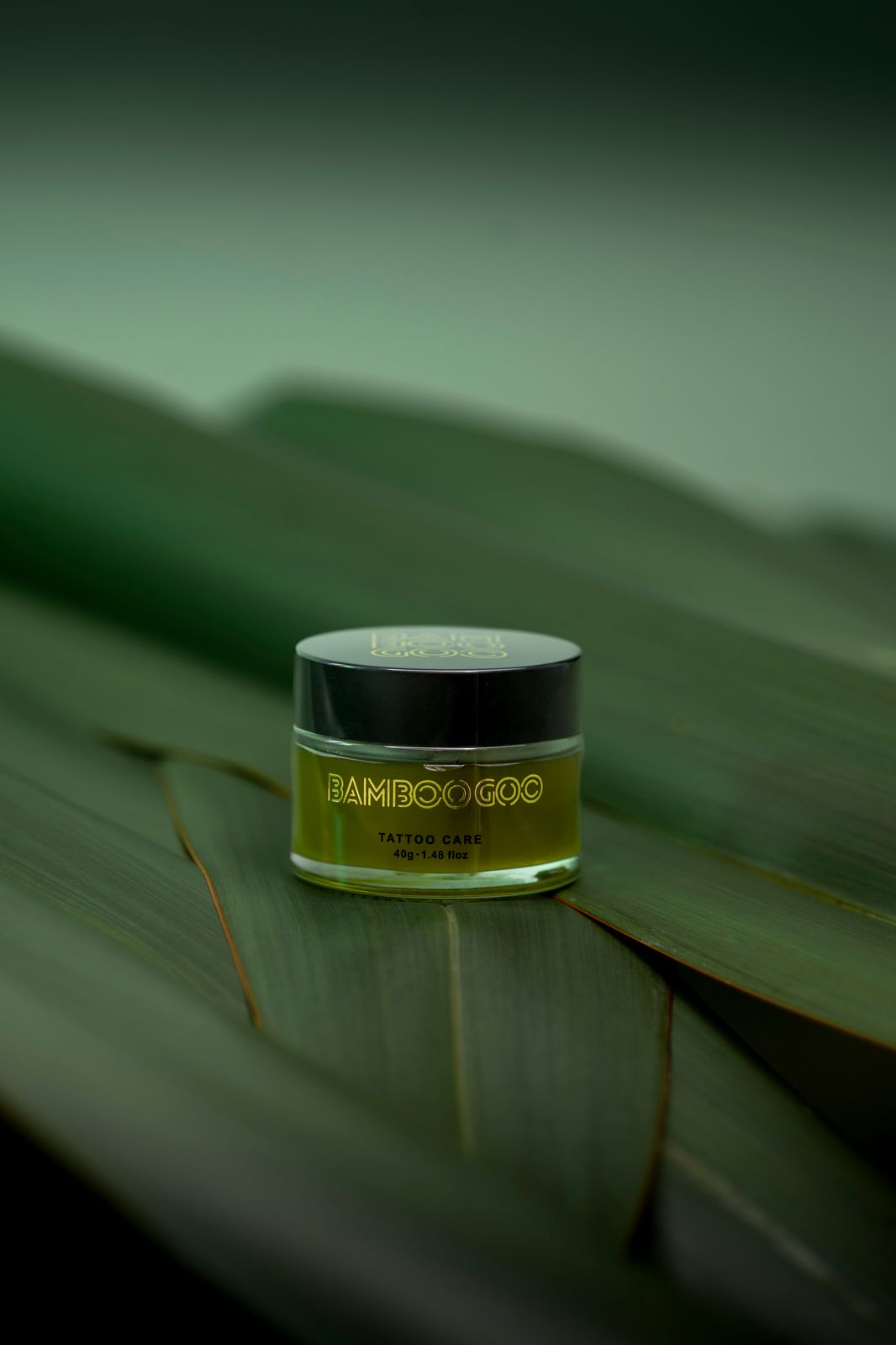 a jar of cream sitting on top of a leaf