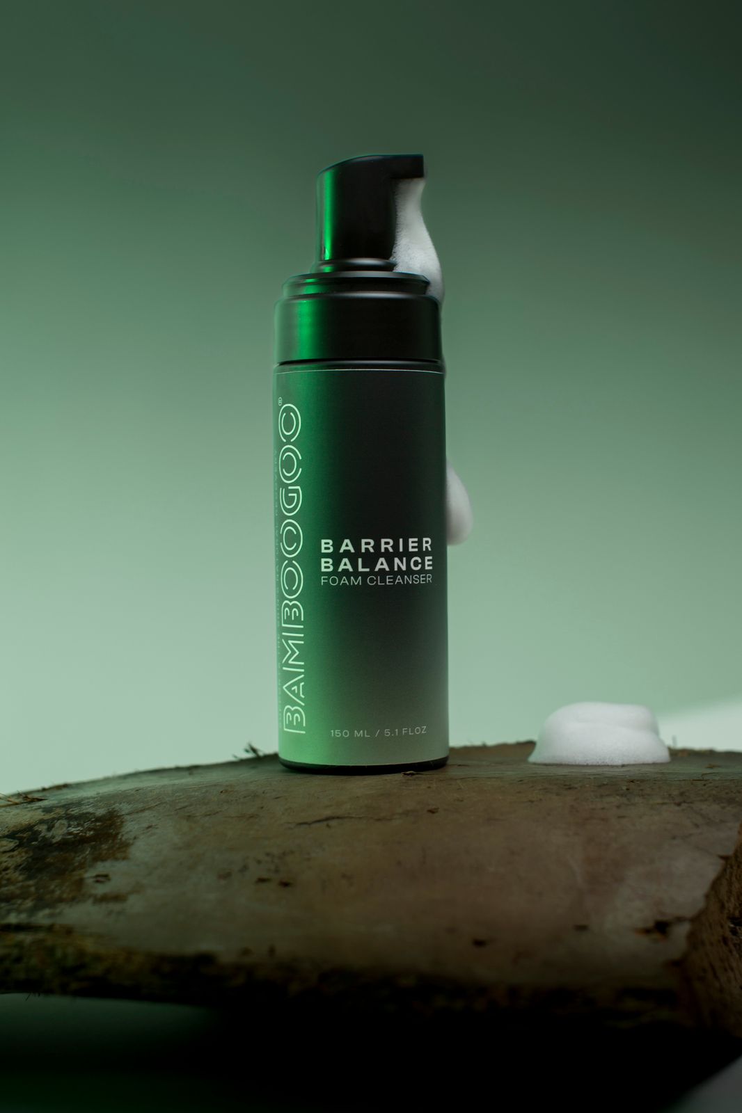 a bottle of shampoo sitting on top of a piece of wood