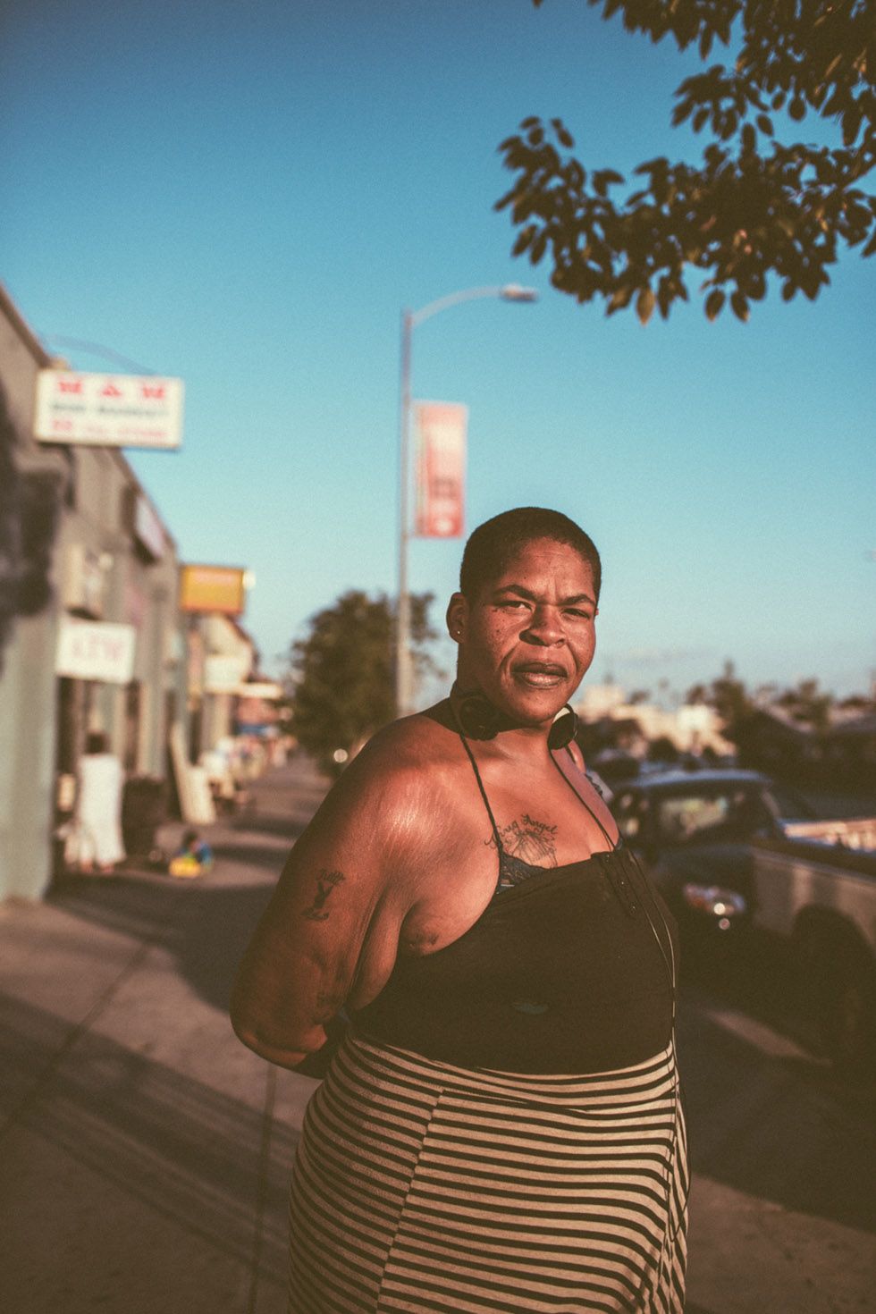 a woman standing on the side of a road