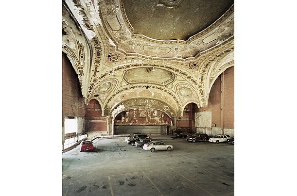 an old building with a lot of cars parked inside of it