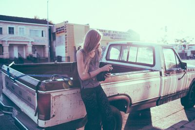 a woman sitting in the back of a pickup truck