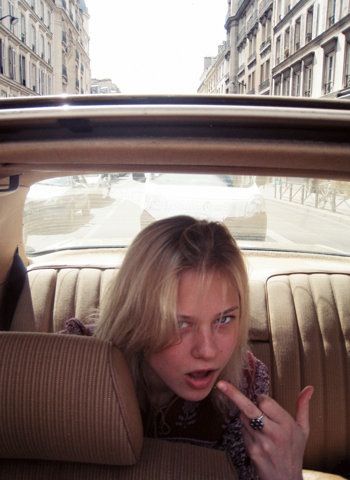 a woman sitting in the back seat of a car