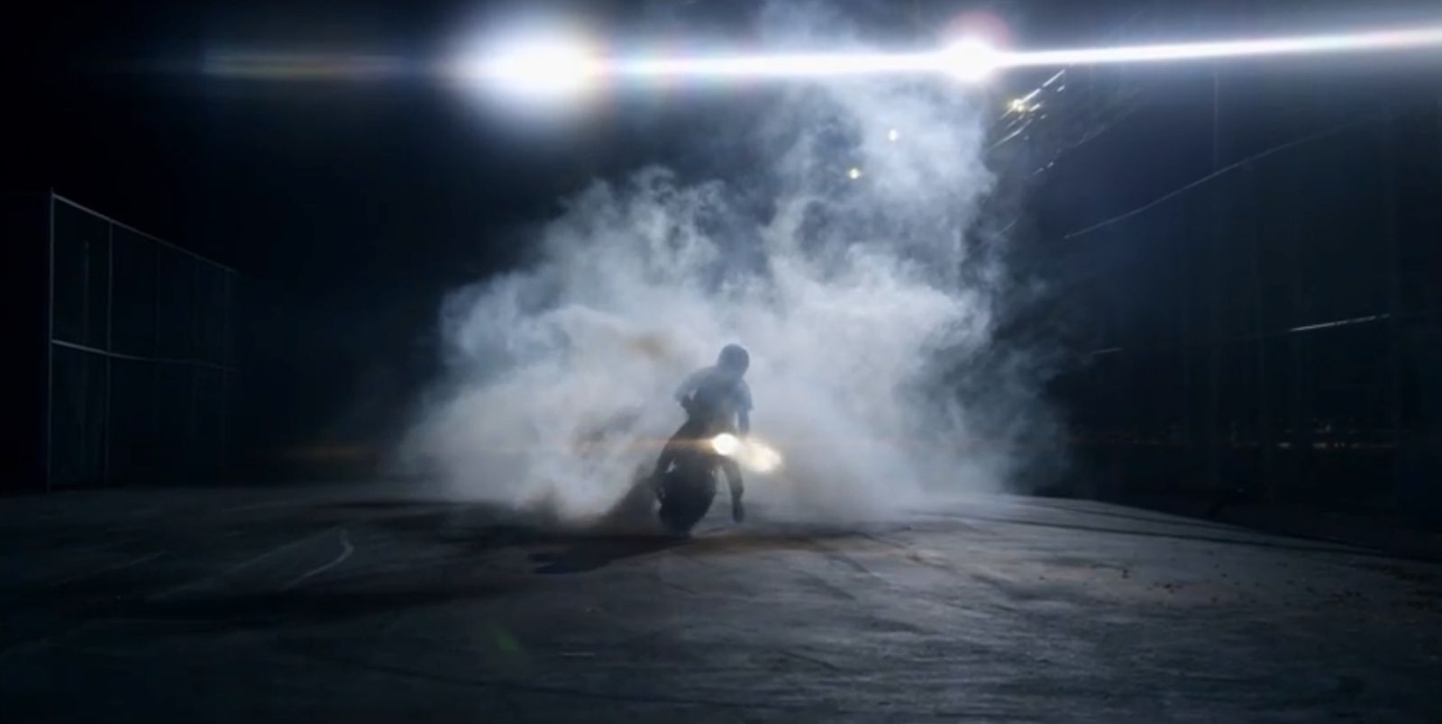 a person riding a motorcycle on a dark street