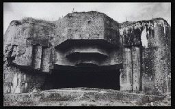 a black and white photo of a cave entrance