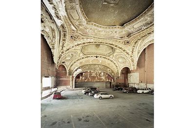 an old building with a lot of cars parked inside of it