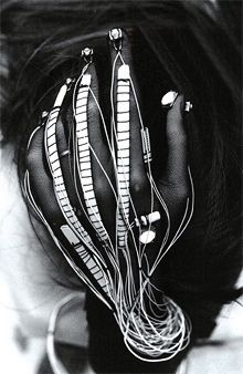 a black and white photo of a woman's head with wires attached to her