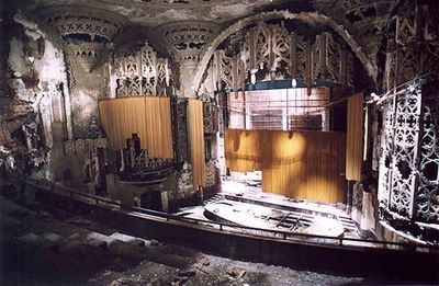 an abandoned theater with a wooden stage