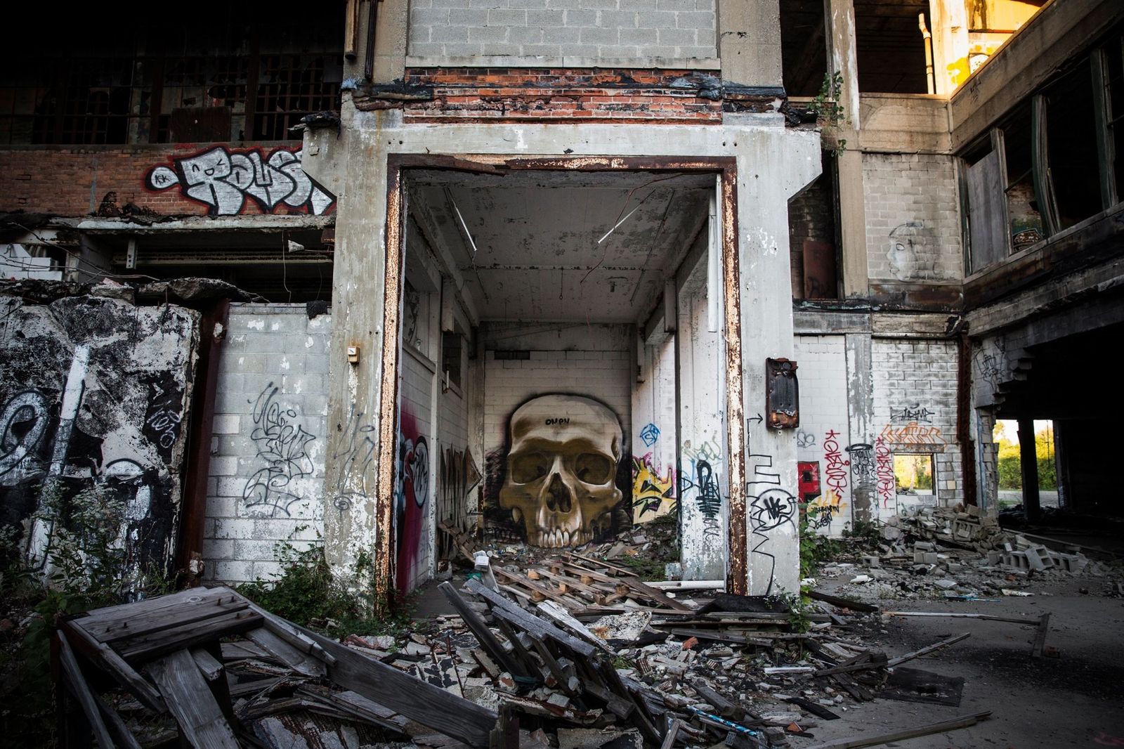 an abandoned building with graffiti and a skull in the doorway