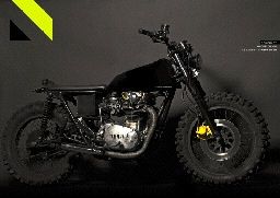 a black motorcycle parked in a dark room