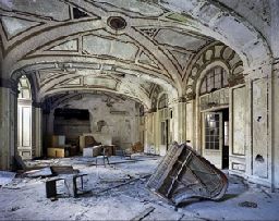 an abandoned building with a bunch of furniture in it