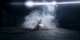 a person riding a motorcycle on a dark street