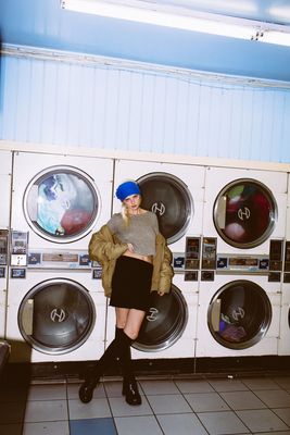 a woman standing in front of a stack of washers