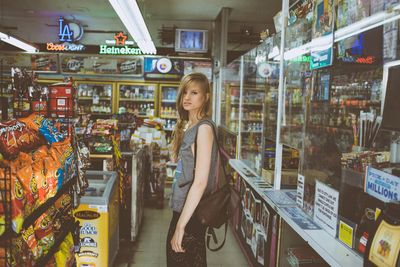 a woman standing in a store with a handbag