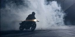 a person riding a motorcycle on a street