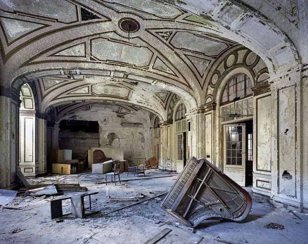 an abandoned building with a bunch of furniture in it