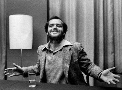 a black and white photo of a man sitting at a desk