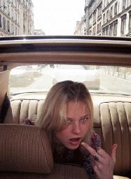 a woman sitting in the back seat of a car