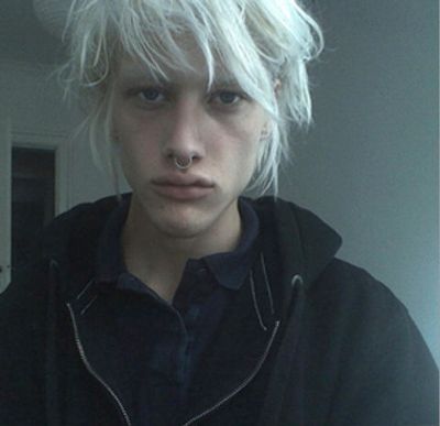 a young man with blonde hair and a nose piercing