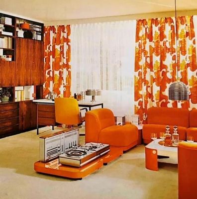 a living room with orange furniture and curtains