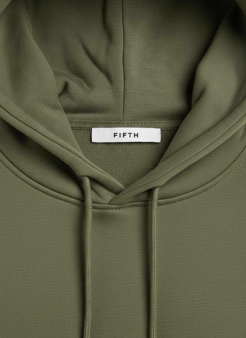 a close up of a green hoodie with a tag on it
