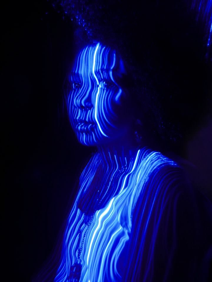 a woman with blue light painted on her face