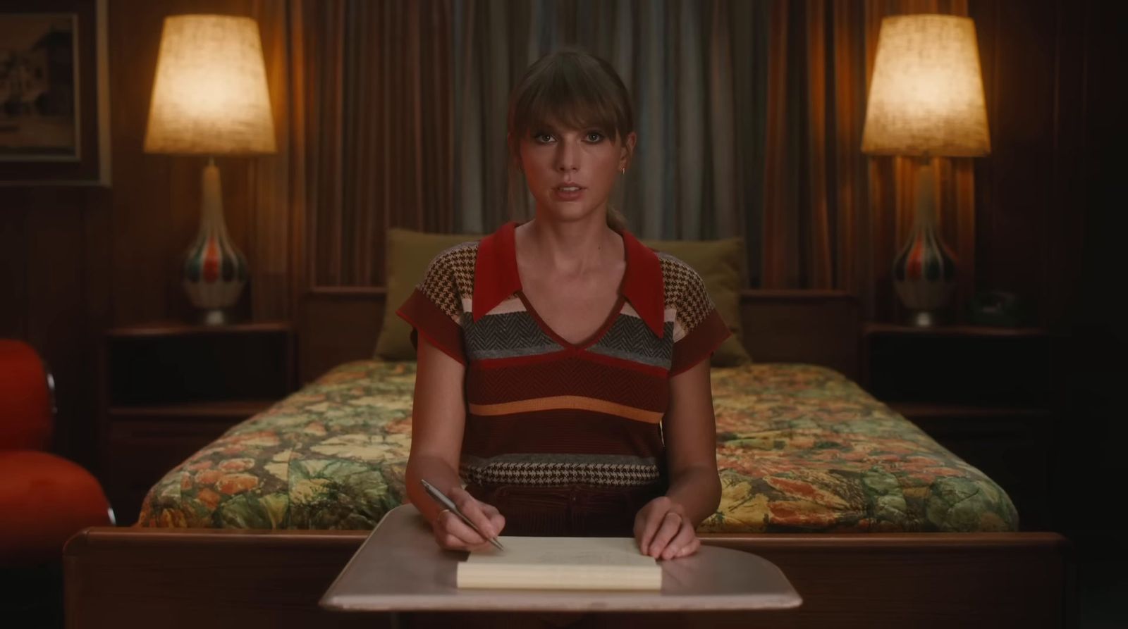 a woman sitting at a table in a hotel room