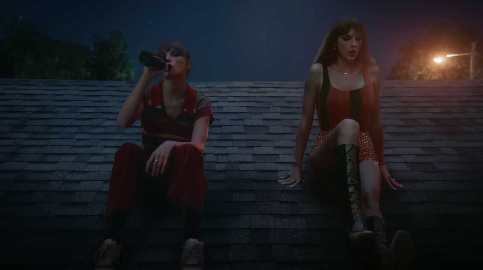 a couple of people sitting on top of a roof