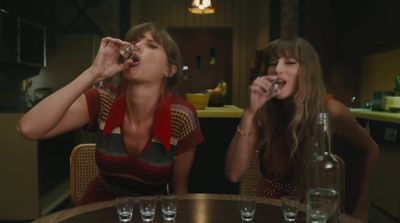 two women sitting at a table with drinks in front of them