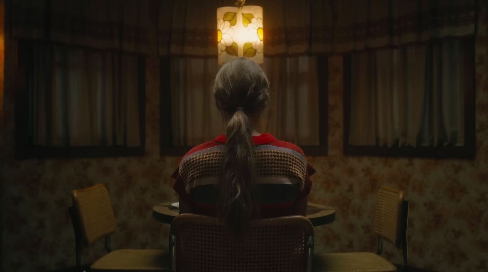 a woman sitting at a table in a room