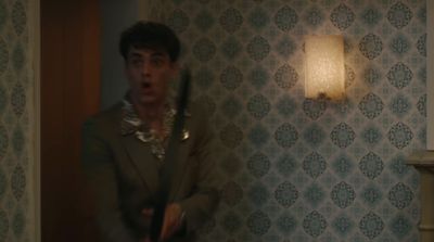 a man holding a bat in a room