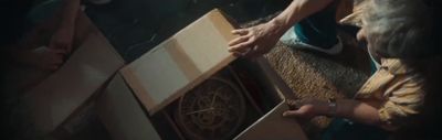 a woman opening a box with a clock in it