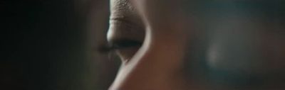 a close up of a woman's face with a blurry background