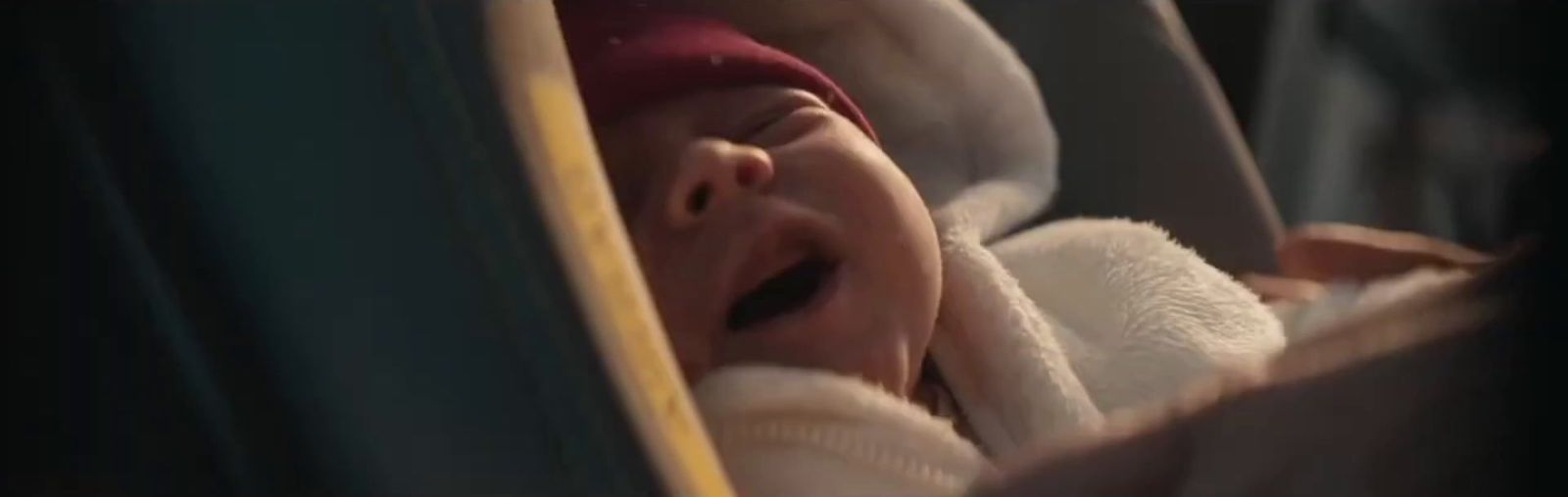 a baby crying in a car seat