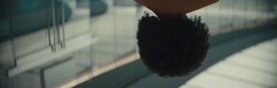 a close up of a person's hair with a blurry background