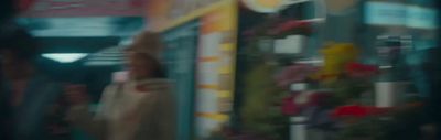 a blurry photo of a woman standing in front of a store